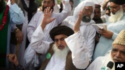 FILE - Khadim Hussain Rizvi, leader of Pakistani religious party Tehreek-i-Labaik waves to his supporters during a march, Aug. 29, 2018, in Lahore, Pakistan.