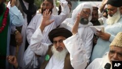 FILE - Khadim Hussain Rizvi, leader of Pakistani religious party Tehreek-i-Labaik waves to his supporters during a march, Aug. 29, 2018, in Lahore, Pakistan.