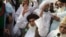 FILE - Khadim Hussain Rizvi, leader of Pakistani religious party Tehreek-i-Labaik waves to his supporters during a march, Aug. 29, 2018, in Lahore, Pakistan.