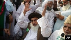 FILE - Khadim Hussain Rizvi, leader of Pakistani religious party Tehreek-e-Labbaik Pakistan, waves to his supporters during a march, Aug. 29, 2018, in Lahore, Pakistan.