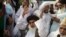 FILE - Khadim Hussain Rizvi, leader of Pakistani religious party Tehreek-i-Labaik waves to his supporters during a march, Aug. 29, 2018, in Lahore, Pakistan.
