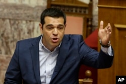 FILE - Greek Prime Minister Alexis Tsipras answers opposition questions in parliament in Athens, July 31, 2015.