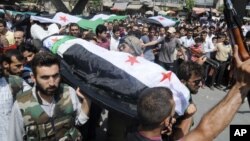 People carry a body of a person killed in clashes in Aleppo, Syria, Friday, July 27, 2012. 