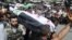 People carry a body of a person killed in clashes in Aleppo, Syria, Friday, July 27, 2012. 
