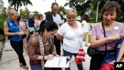 Campaign Florida residents stand in line to register to vote in November elections, in Miami, Oct. 11, 2016.