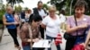 FILE - Florida residents stand in line to register to vote in November elections, in Miami, Oct. 11, 2016.