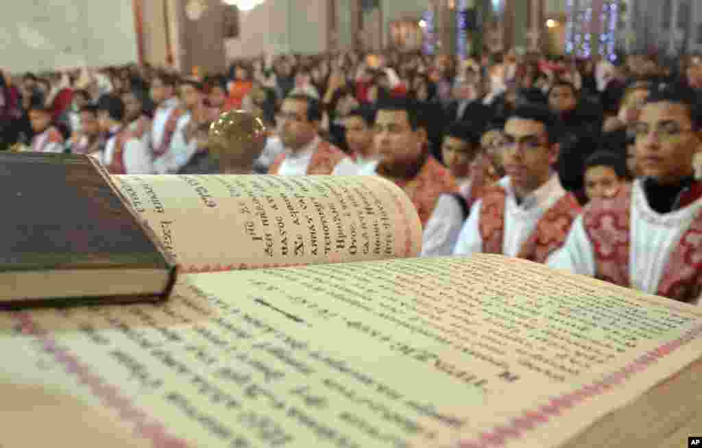 In this Friday, Jan. 6, 2012 photo, Egyptians attend Christmas Eve mass at a Coptic church in Qena, Egypt. Egypt's Christians celebrated Saturday their first Christmas after the ouster of President Hosni Mubarak, amid tight security and a display of natio