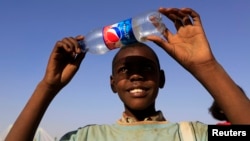 FILE - A boy observes a solar eclipse during an event organized by the Sudanese Society for Astronomy and Space Science on the banks of the Nile river in Khartoum Nov. 3, 2013.