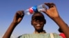 FILE - A boy observes a solar eclipse during an event organized by the Sudanese Society for Astronomy and Space Science on the banks of the Nile river in Khartoum Nov. 3, 2013.