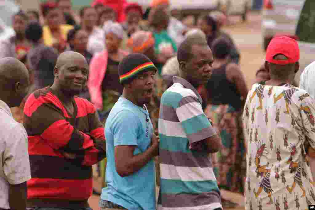 Zambians wait in a queue to cast their ballot on presidential election day in Lusaka, Tuesday, Jan. 20, 2015.