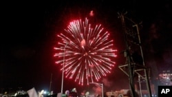 People watch fireworks during the Independence Day celebrations in Karachi, Pakistan, Aug. 14, 2020. 