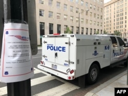 A sign is posted on "first ammendment activities" and the prohibition of firearms as police patrol a street two blocks from the White House on Aug. 12, 2018 in Washington, DC.