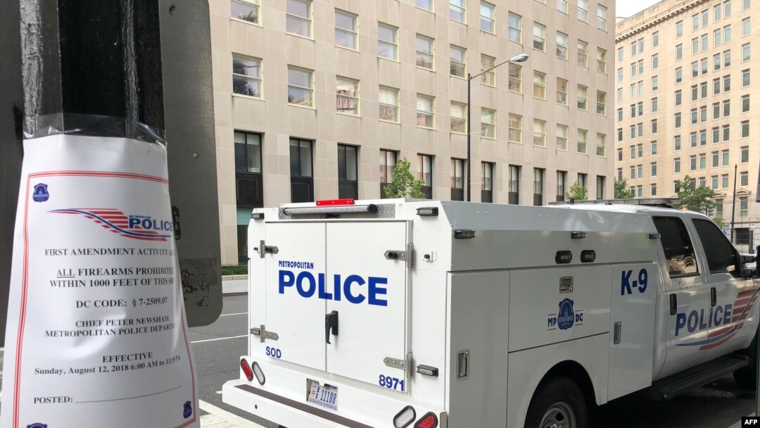 A sign is posted on "first ammendment activities" and the prohibition of firearms as police patrol a street two blocks from the White House on Aug. 12, 2018 in Washington, DC.