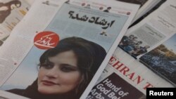 Newspapers with Amini, a victim of country's "morality police", are seen in Tehran
