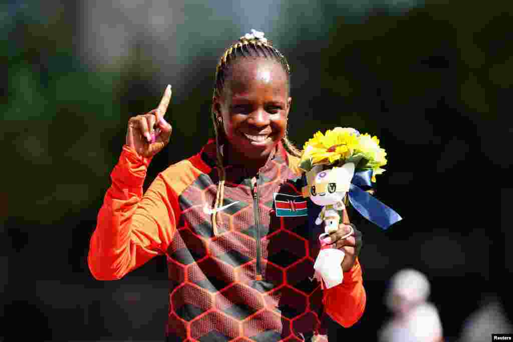 Gold medallist Peres Jepchirchir of Kenya celebrates on the podium REUTERS/Feline Lim