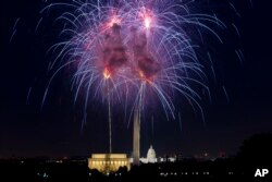 Fireworks explode over Lincoln Memorial, Washington Monument and U.S. Capitol along the National Mall in Washington, July 4, 2018, during the Fourth of July celebration.