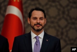 Berat Albayrak, Turkey's newly appointed Finance Minister, listens to President Erdogan as he presents his new cabinet during a news conference at Presidential Palace, in Ankara, Turkey, July 9, 2018.