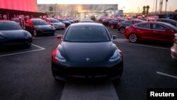 Tesla Model 3 cars are seen at an event at the factory handing over its first 30 Model 3 vehicles to employee buyers at the company’s Fremont facility in California, July 28, 2017. 