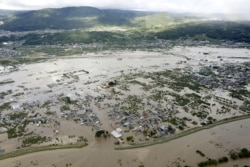 An aerial view shows residential areas flooded by the Chikuma river, caused by Typhoon Hagibis in Nagano, central Japan, Oct. 13, 2019, in this photo taken by Kyodo.