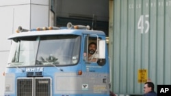 A California Highway Patrol commercial vehicle inspector directs a truck entering the U.S. from Mexico. (file)