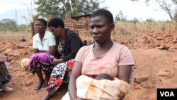 A teenage mother sits with other women, in Phalombe district, Malawi. (Lameck Masina/VOA)