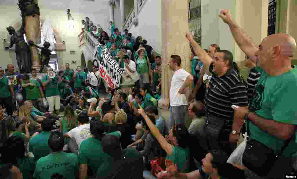 Activists of the PAH mortgage victims platform occupy a branch of the BBVA bank to demand the renegotiation of the mortgages of 232 families, in Sabadell, near Barcelona, Spain. 