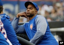 New York Mets' Yoenis Cespedes, who is currently injured, watches his team play the San Diego Padres on July 24, 2018, in New York. The former Cuban player has been in major leagues in the United States since 2012.