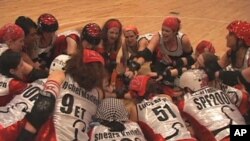 The D.C. Demon Cats, an all-women's roller derby team, huddle before their opening match of the season