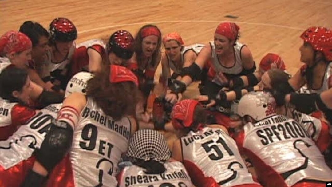 The D.C. Demon Cats, an all-women's roller derby team, huddle before their opening match of the season