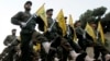 FILE - Hezbollah fighters parade in a southern suburb of Beirut, Lebanon, Nov. 12, 2010.