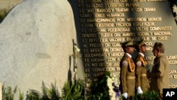 FILE - Cuba's President Raul Castro stands before the tomb of his brother, Cuba's late leader Fidel Castro, on the one year anniversary that Fidel was buried, in Santiago, Cuba, Dec. 4, 2017. 