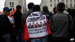 FILE - A protester wears a Peruvian flag covered with images of lawmakers and the Spanish message "No more corruption" in Lima, Peru, July 19, 2018.