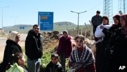 Syrian refugees gather up before a walk outside their camp in Reyhanli, Turkey, Sunday, March 4, 2012. 