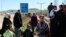 Syrian refugees gather up before a walk outside their camp in Reyhanli, Turkey, Sunday, March 4, 2012. 