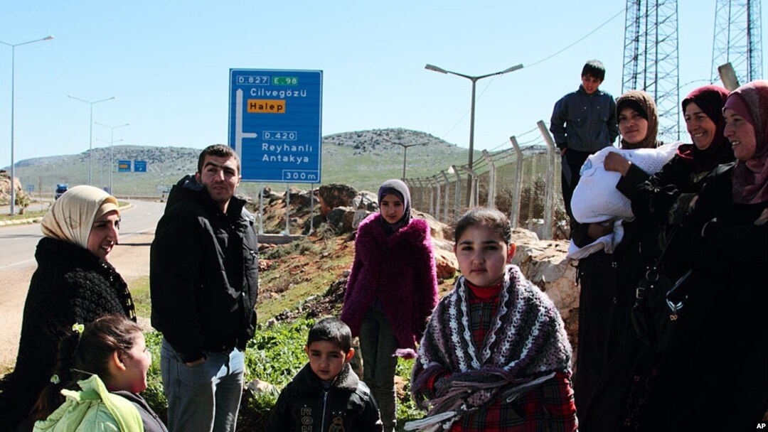 Syrian refugees gather up before a walk outside their camp in Reyhanli, Turkey, Sunday, March 4, 2012. 