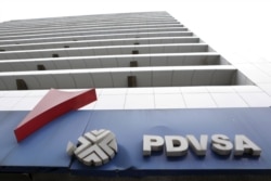 FILE - The PDVSA logo for Venezuela's state-owned oil company is seen at a gas station in Caracas.