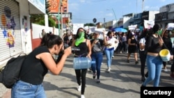 Journalists cover an International Women's Day protest in Tapachula, Mexico. A joint partnership is offering training and support to women in media and politics in Mexico, Kenya and Sri Lanka. (Courtesy - IWMF)