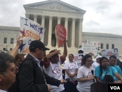 Demonstrators gather outside the Supreme Court after a tied vote in the court thwarted President Barack Obama's plan to defer the deportation of millions of undocumented immigrants.