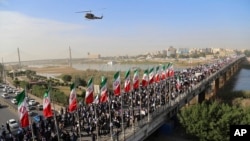 In this photo provided by Mehr News Agency, demonstrators attend a pro-government rally in the southwestern city of Ahvaz, Iran, Jan. 3, 2018. 