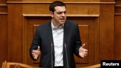 Greek Prime Minister Alexis Tsipras delivers his first major speech in parliament in Athens, Feb. 8, 2015. 