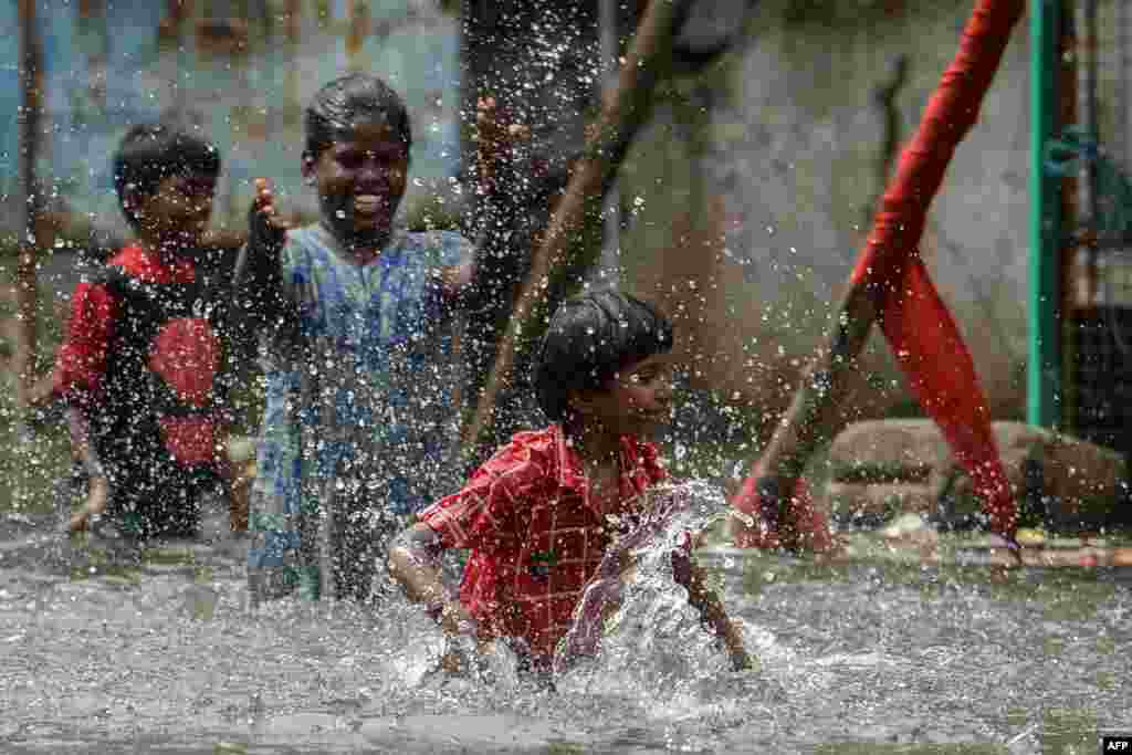 Children play at a waterlogged street near a residential area after heavy monsoon rainfall in Chennai, India.
