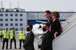 U.S. Secretary of State Mike Pompeo, top left, arrives with his wife Susan Pompeo, top right, at the airport in Prague, Czech Republic, Aug. 11, 2020.
