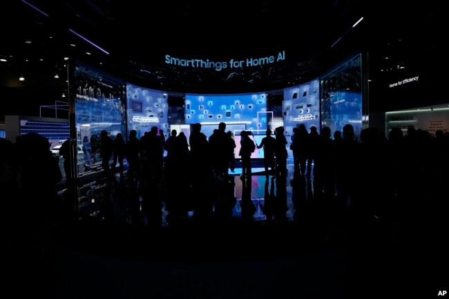 FILE - People look at a display of Samsung screens and products at the CES tech show Tuesday, Jan. 7, 2025, in Las Vegas. (AP Photo/Abbie Parr)