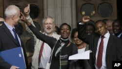 Supporters cheer outside the Royal Courts of Justice in London following a verdict in the Mau Mau torture compensation claim case, October 5, 2012.