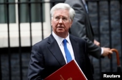 FILE - Britain's Minister of Defense Michael Fallon leaves 10 Downing Street after a cabinet meeting, in London, Britain, June 27, 2017.
