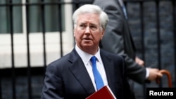 FILE - Britain's Minister of Defense Michael Fallon leaves 10 Downing Street after a cabinet meeting, in London, Britain, June 27, 2017.