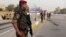 Iraqi security forces stand guard as they check motorists entering the heavily fortified Green Zone in Baghdad, Iraq, Oct. 5, 2015.