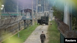 A South Korean soldier walks along a military fence near the demilitarized zone separating the two Koreas in Paju, South Korea, September 28, 2021.