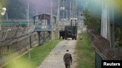 A South Korean soldier walks along a military fence near the demilitarized zone separating the two Koreas in Paju, South Korea, Sep. 28, 2021. 