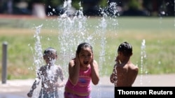Isis Givens-Guttierrez, 9, cools off in Georgetown Playfield splash park during a heat wave in Seattle, Washington, June 26, 2021. 